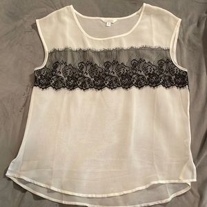 Charming Charlie shear white blouse with black lace braline on front and back.